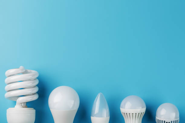 istock Energy-Saving light bulbs are arranged in a row on a blue background, top view. 1279166991