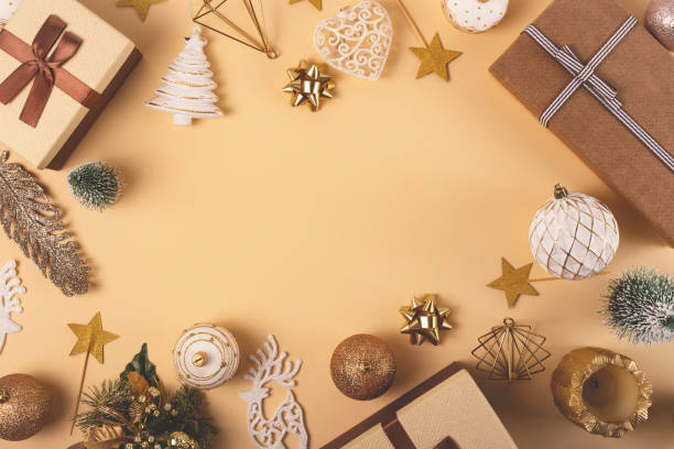 Three Christmas gift boxes on a neutral background among decorations