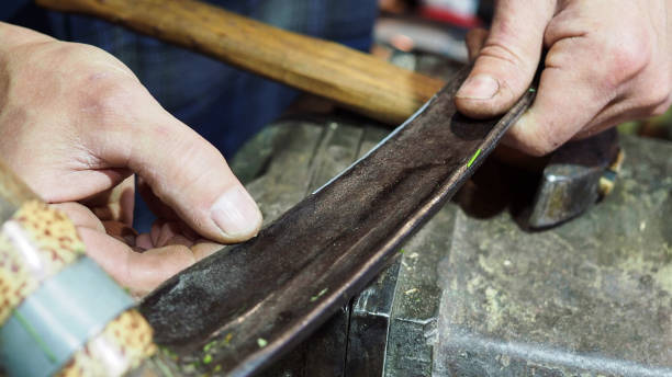 istock village blacksmith checks sharpness of scythe 1279167252