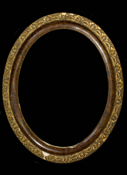 istock Old oval wooden picture frame isolated on black background. 1279169954