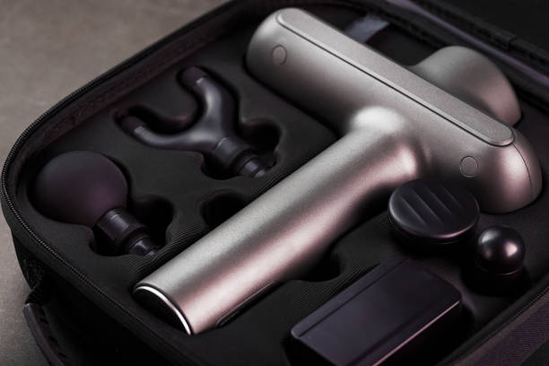 istock Electric massager Machine for body massage in a case on a black background. 1279171450
