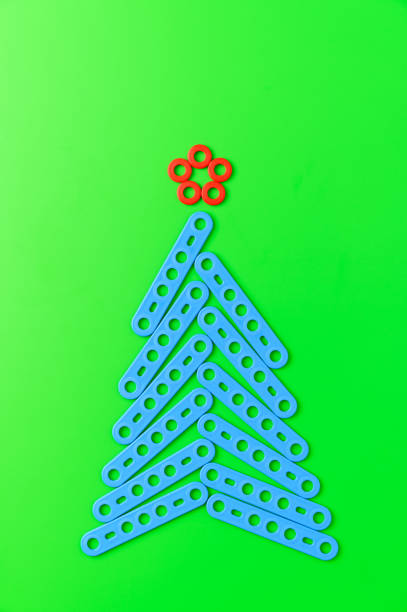 istock Alternative Christmas tree made from a toy construction set on a green background. 1279172797