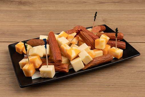 A tasty cheddar cheese and pepperoni appetizer plate for a party