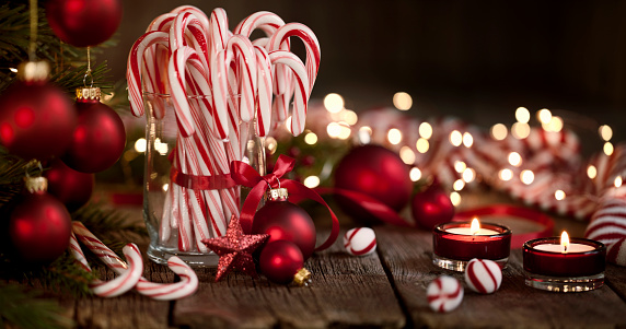 Candy Canes and Bright Christmas Lights on an Old Wood Background