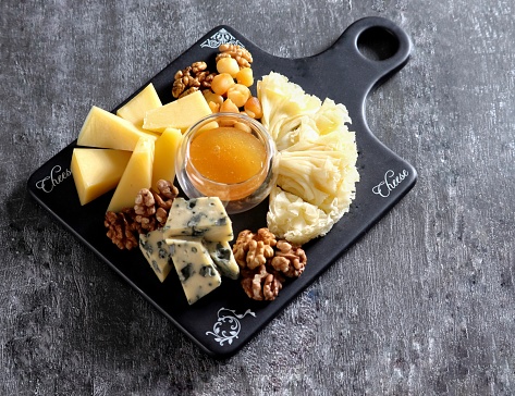 Cheese plate on a gray background
