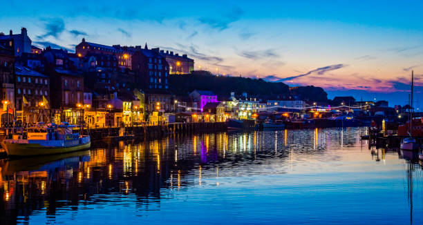Whitby Harbour at night with sunset sky taken at Whitby, Yorkshire, UK stock photo
