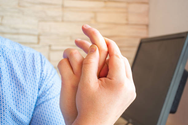 Patient holds onto index finger and indicates localization of pain, inability to move, numbness and other symptoms due to trauma, damage to nerves or joints. Concept photo of arthritis, neuritis Patient holds onto index finger and indicates localization of pain, inability to move, numbness and other symptoms due to trauma, damage to nerves or joints. Concept photo of arthritis, neuritis index finger stock pictures, royalty-free photos & images