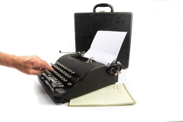 istock one finger typing on an old black portable typewriter isolated on white 1279179014