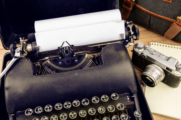 istock an old 1940s black portable typewriter with a old 35 mm film camera and a notebook suggesting a  writer's workstation 1279179241