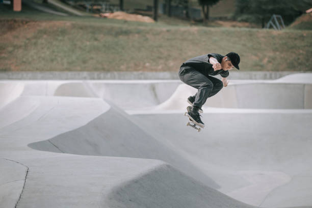 istock Asian skateboarder in action mid air x games 1279179973