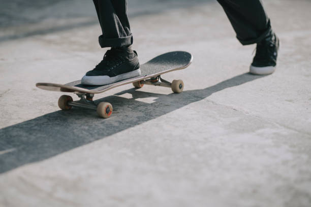asian skateboarder's leg playing skateboarding with shadow asian skateboarder's leg playing skateboarding with shadow extreme skateboarding stock pictures, royalty-free photos & images