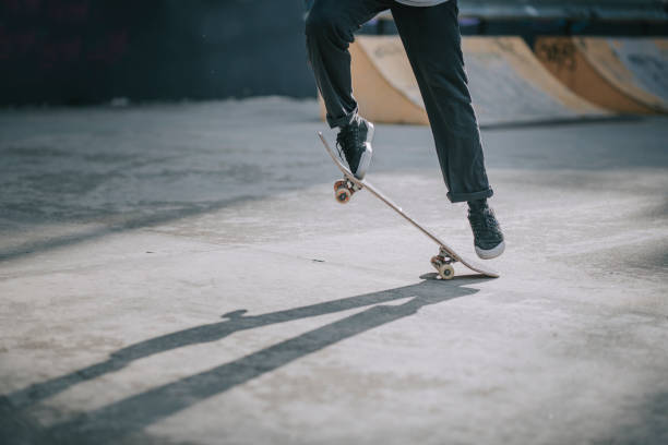 asian skateboarder's leg playing skateboarding with shadow asian skateboarder's leg playing skateboarding with shadow Ollie stock pictures, royalty-free photos & images