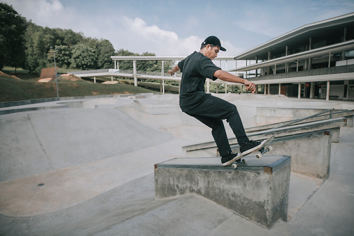 Asian skateboarder in action x games