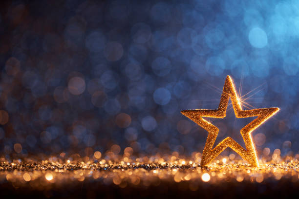 Sparkling Golden Christmas Star - Ornament Decoration Defocused Bokeh Background Decorative Christmas still life photography. special occasions stock pictures, royalty-free photos & images