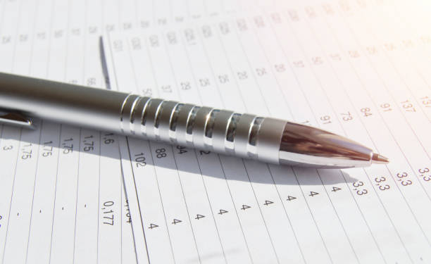 istock Silver pen on financial reports with Analytics and summaries, business concept, light and sunlight 1279184517