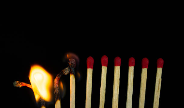 istock Group of red match burning isolated on black background. 1279186056