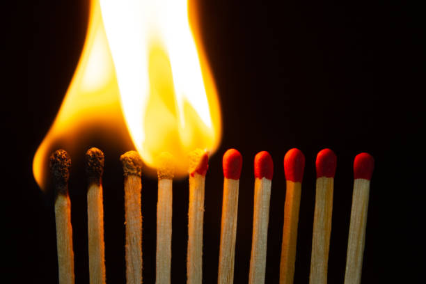 istock Group of red match burning isolated on black background. 1279186185