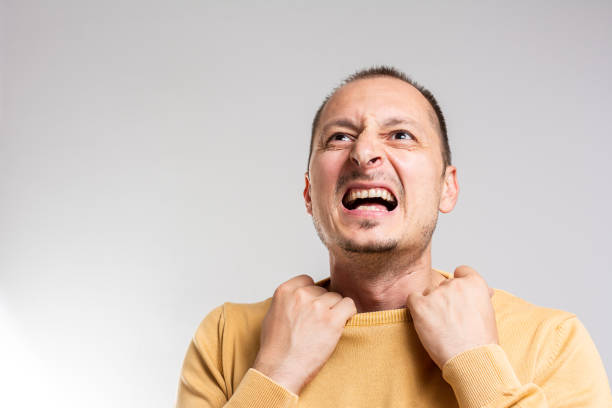 istock man in yellow sweater feeling uncomfortable 1279186774