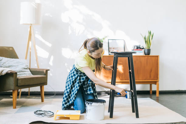 istock Woman painting stool at home 1279187812