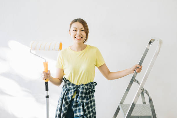 istock Portrait of woman with paint roller 1279187843