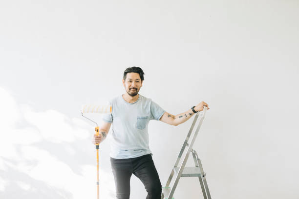 istock Portrait of man with paint roller 1279187855