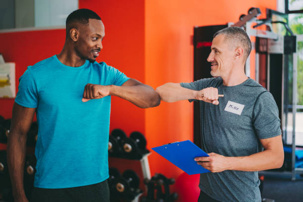 istock Sports training in the gym with personal trainer 1279189392