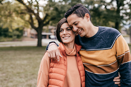 Hispanic couple in the park - portrait with copy space