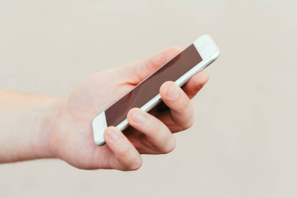 istock male hands holding a modern phone mock-up for your text message or information content, on a light blurred background 1279192071