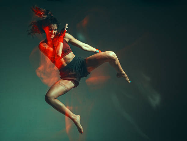 istock A young female fighter performs a jump kick. Long exposure shot 1279192153