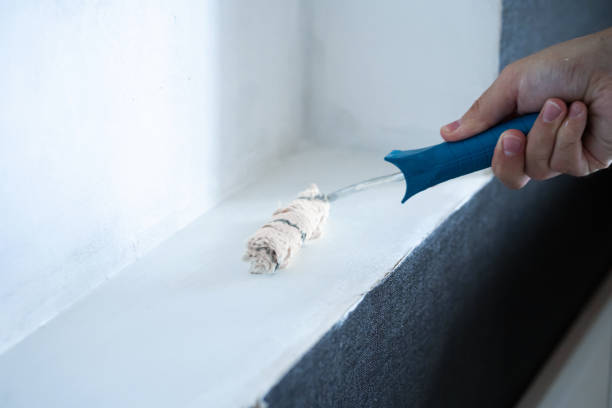 istock Renovation in the house. Painting a white wall with a roller with white paint. Rolling paint with a hand roller. Updating the paint on the wall. 1279192911