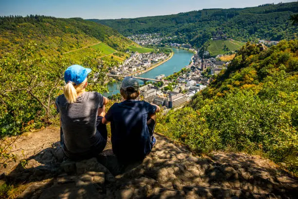 mother and son hiking in Germany. looking down to Cochem and River Mosel