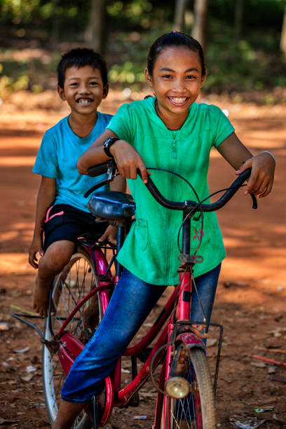 istock Cambodian children riding bicycle, Cambodia 1279196754