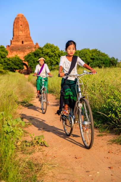 istock Burmese school children riding a bicycle in Bagan, Myanmar 1279196919