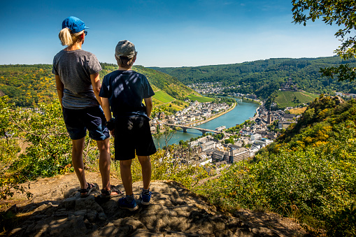 mother and son looking down to Cochem and River Mosel in Germany