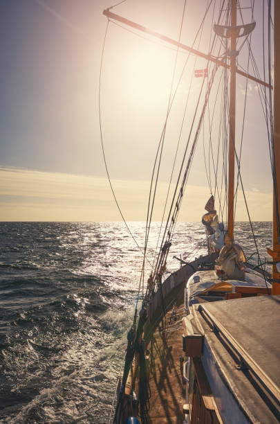 istock Sailing old schooner at orange sunset. 1279197815