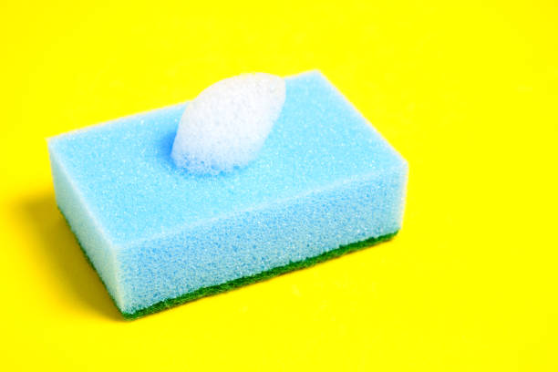 istock Blue sponge for washing dishes on a yellow background. 1279198055