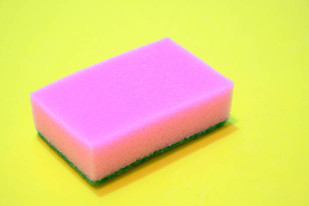istock Pink sponge for washing dishes on a yellow background. 1279198057