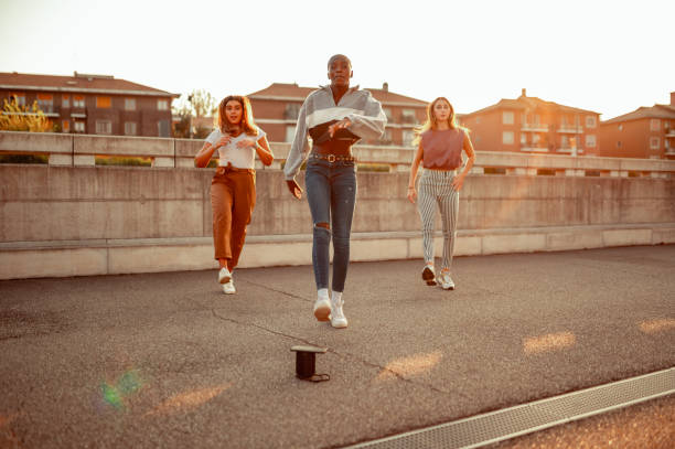 Dancing group Three young women dancing on the street dance troupe stock pictures, royalty-free photos & images