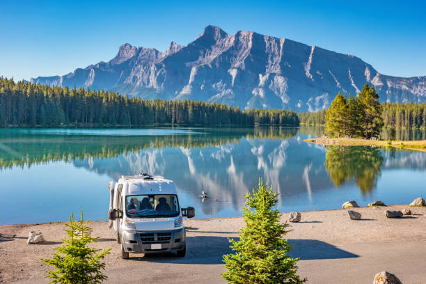 RV van in Banff National Park Alberta Canada Tranquil Landscape with an RV van at Two Jack Lake, Banff National Park, Alberta Canada on a sunny morning. alberta photos stock pictures, royalty-free photos & images