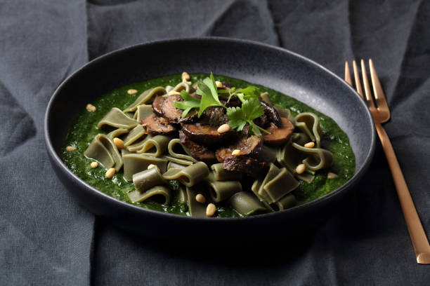 istock Spirulina pasta with mushrooms, spinach sauce and pine nuts 1279199277