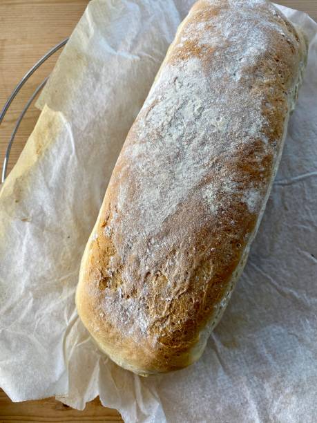 istock Home made floured loaf in baking paper 1279199970