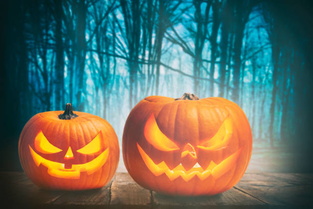 istock Pumpkin Burning In A Spooky Forest At Night - Halloween Background 1279200597