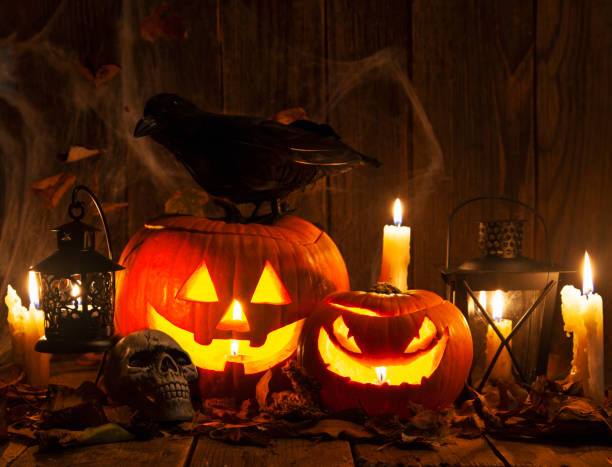 Halloween Jack-o-Lantern Pumpkins on rustic wooden background