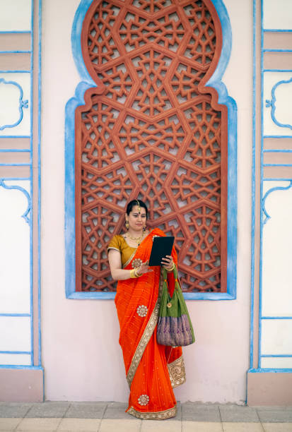 istock Smiling beautiful Indian girl using her digital tablet 1279201066