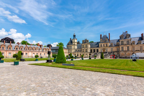 Fontainebleau palace (Chateau de Fontainebleau) in summer, France Fontainebleau, France - May 2019: Fontainebleau palace (Chateau de Fontainebleau) in summer chateau de fontainbleau stock pictures, royalty-free photos & images