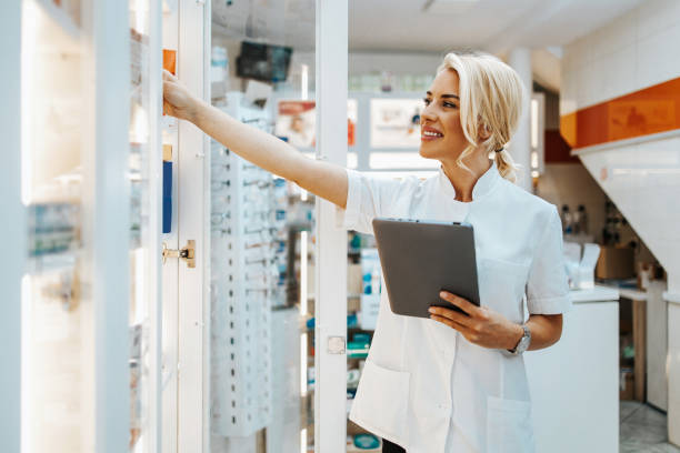 istock Young female pharmacist working in drugstore 1279203667