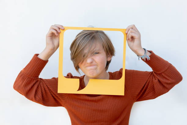 istock Angry Caucasian Tween Girl Showing Dislike Feedback in Yellow Speech Text Bubble 1279205525