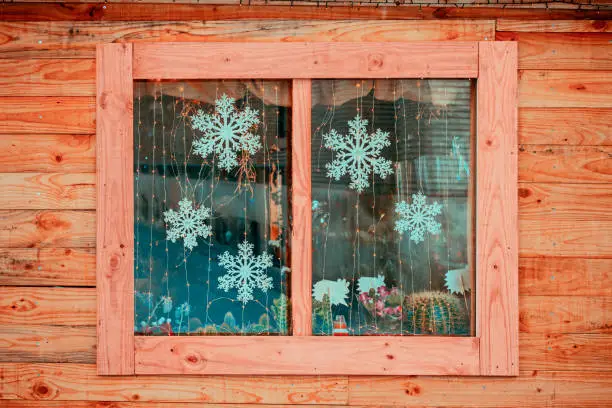 Photo of Christmas decorations through a wooden window