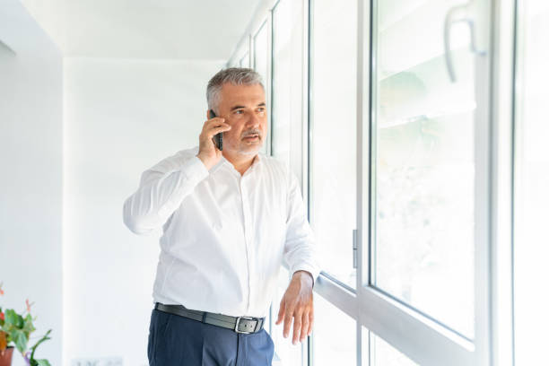 istock Businessman in office talking on phone 1279208124