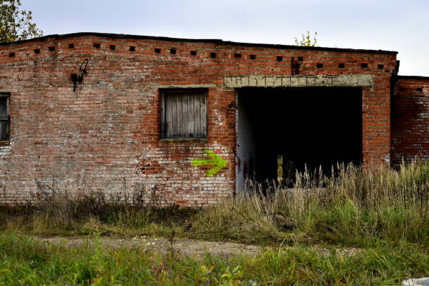 istock old abandoned building overgrown with grass 1279211839